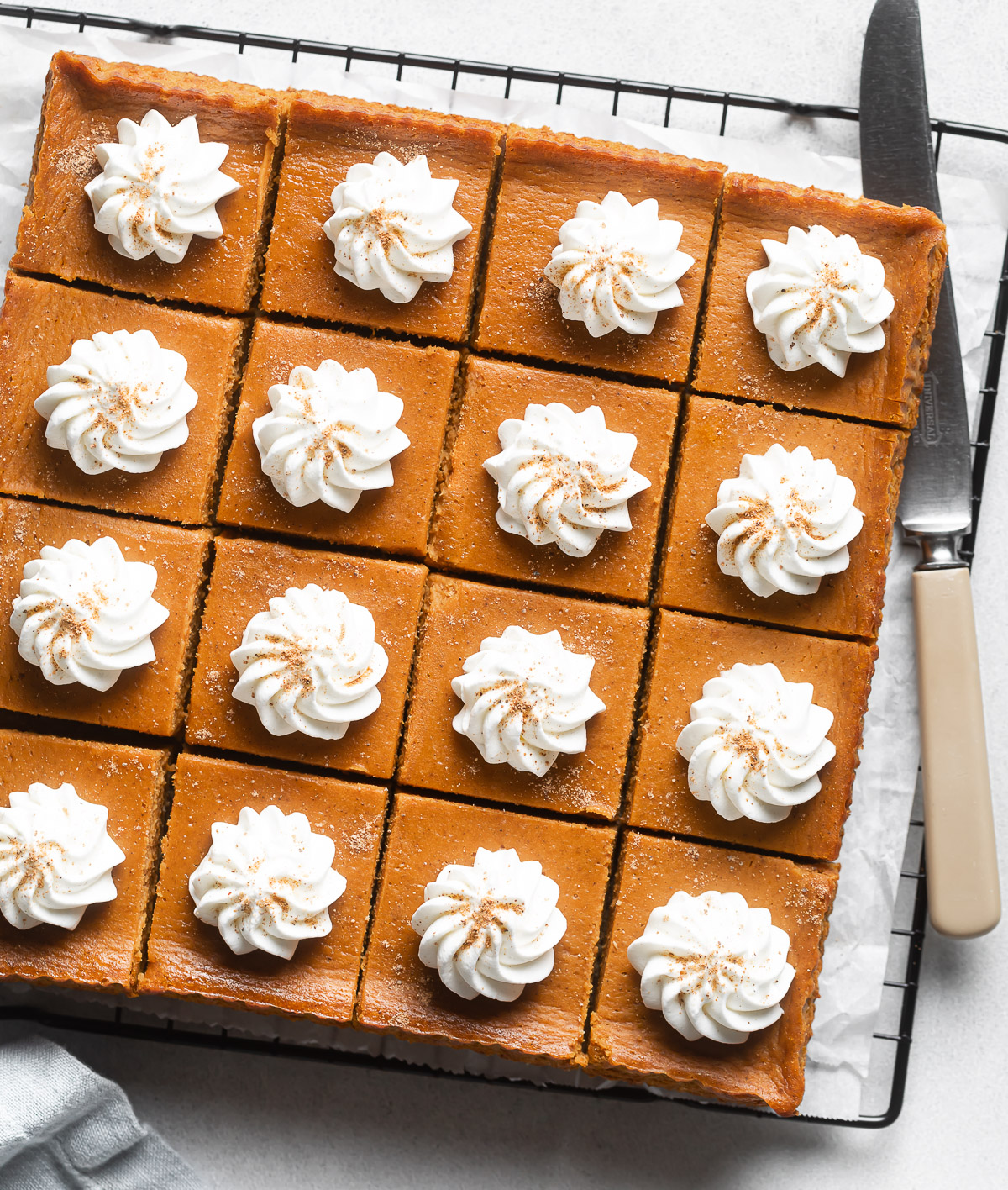 pumpkin pie bars topped with whipped cream